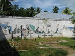 Это не совсем граффити, это барельефы, но суть такая же. Это христианские барельефы, изображающие приезд миссионера на Папуасскую часть Индонезии в район Мерауке