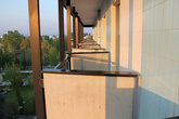 Вид с балкона на соседние балконы, сможете пожимать соседу ручку при случае.