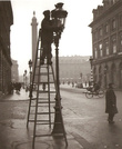 Уличные фонари. Улица Мира. Чистильщики уличных фонарей с 1766 года взбираются на газовые фонари по своим большим лестницам, чтобы поддерживать пламя, чистить стекла и обнаружить утечку (1944 г).