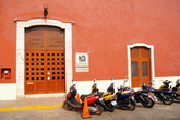 Стоянка мотоциклов у стены дома
