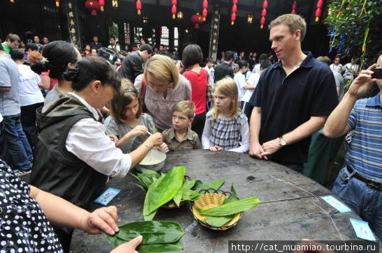 Жители городка Цычикоу учат туристов готовить цзунцзы в празник Дуаньу (праздник лета) . Чунцин, Китай