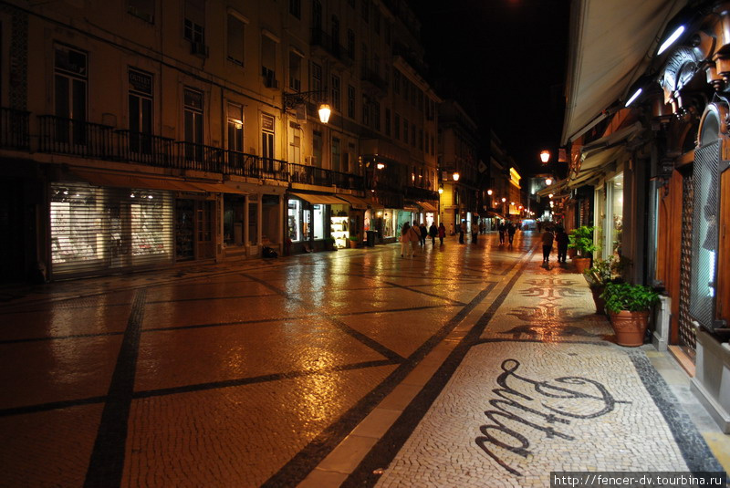 Магазины выкладывают брусчаткой названия перед входом Лиссабон, Португалия