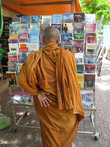 Монах рассматривает книги про геноцид